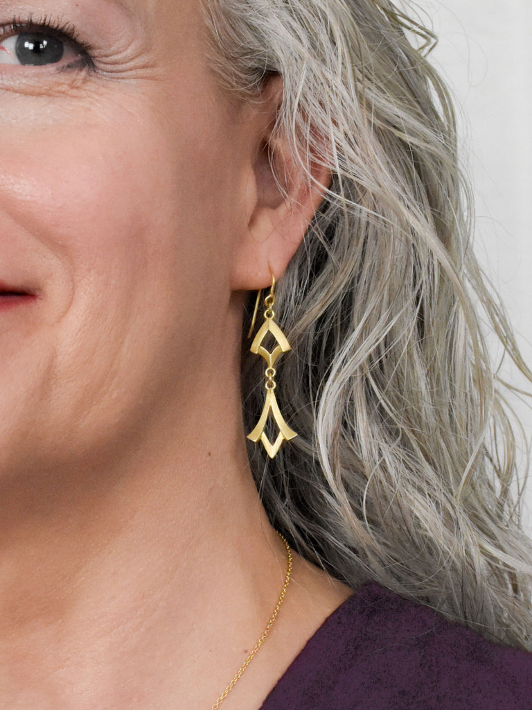 model wearing Art Deco inspired gold earrings from Nikki Lorenz Designs