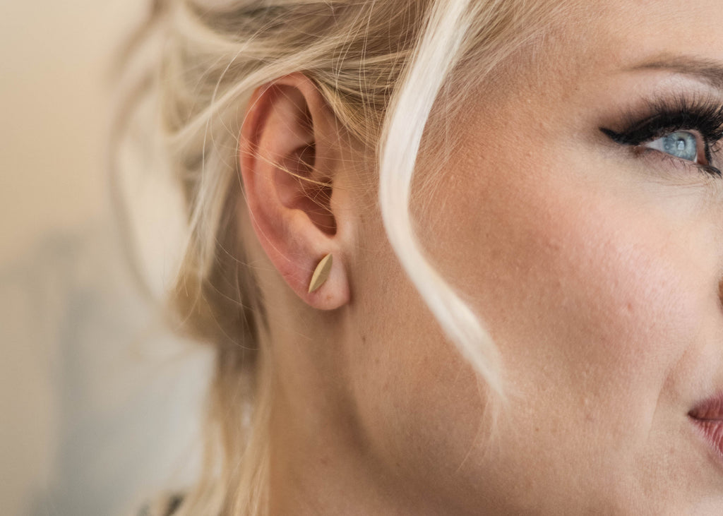 woman wearing unique gold stud earring Nikki Lorenz Designs