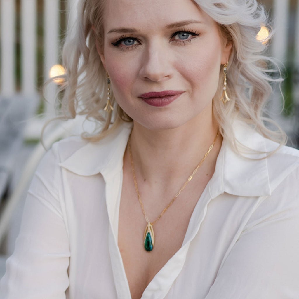 woman in white shirt wearing a custom designed one-of-a-kind malachite, diamond and gold necklace