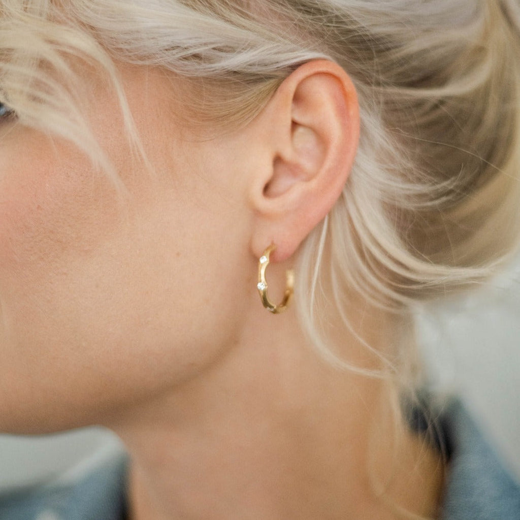 woman wearing gold and diamond hoop earrings from Nikki Lorenz Designs