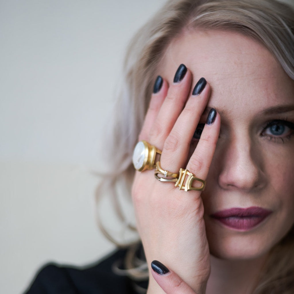 woman wearing large coin pearl ring and other gold stacking rings from Nikki Lorenz Designs