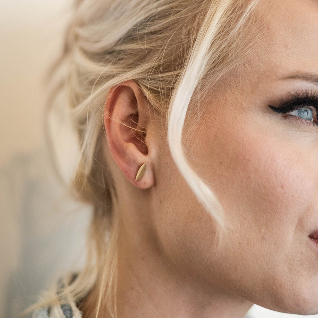 woman wearing modern gold stud earring from Nikki Lorenz Designs
