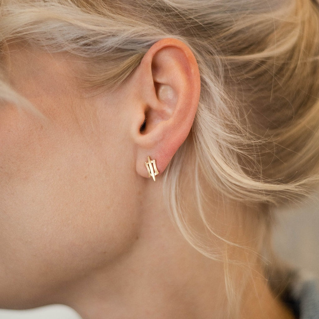 woman wearing modern gold stud earrings from Nikki Lorenz Designs