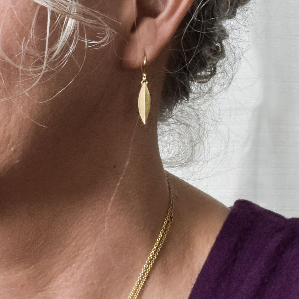 model wearing small 14k gold elongated earring from Nikki Lorenz Designs